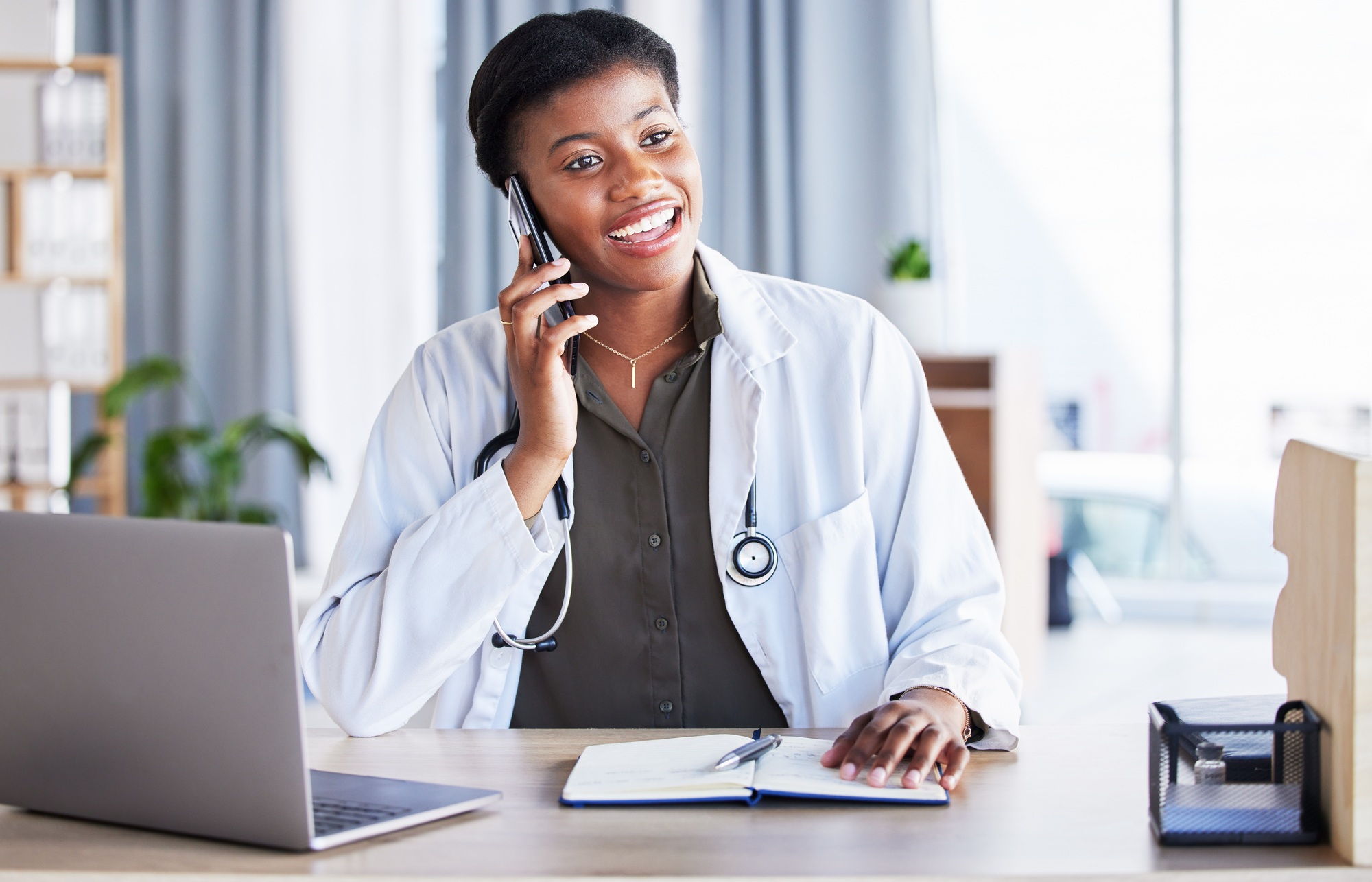 Black woman, doctor and phone call for healthcare consulting, conversation or chat support in clini