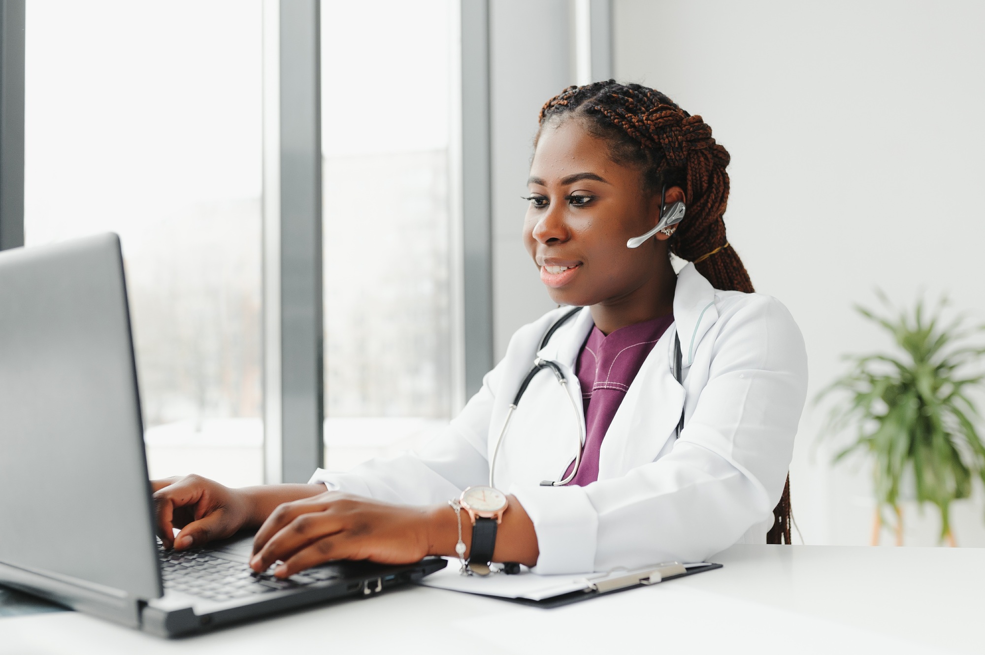 Telehealth, African American doctor in headset consulting with the patient over the phone call